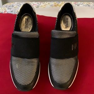 Michael for casual tennis shoes black and gold with a black net in the front